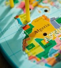 Detailed focus on Algeria with surrounding countries on a colorful world map.